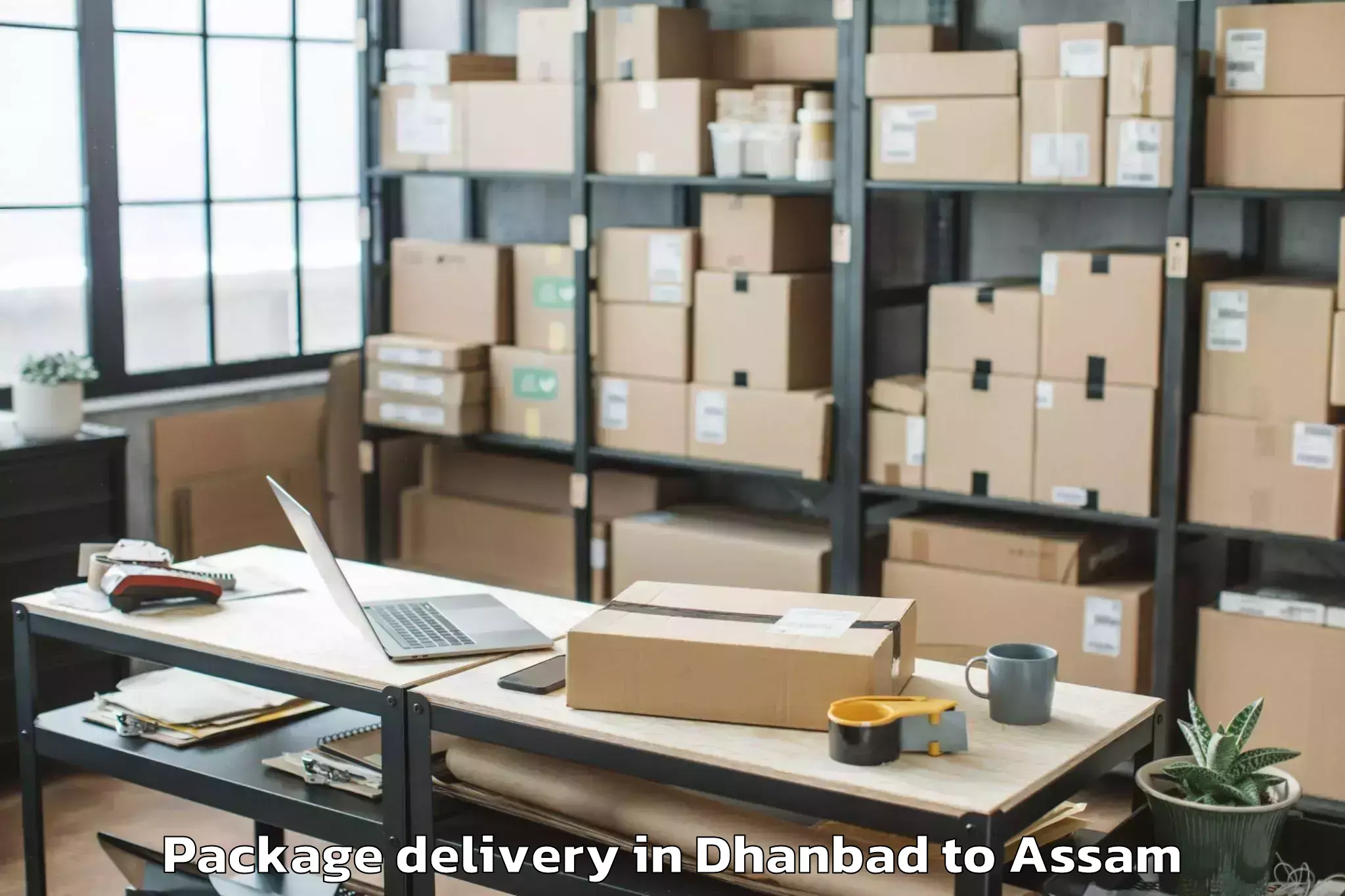 Book Dhanbad to Sualkuchi Package Delivery